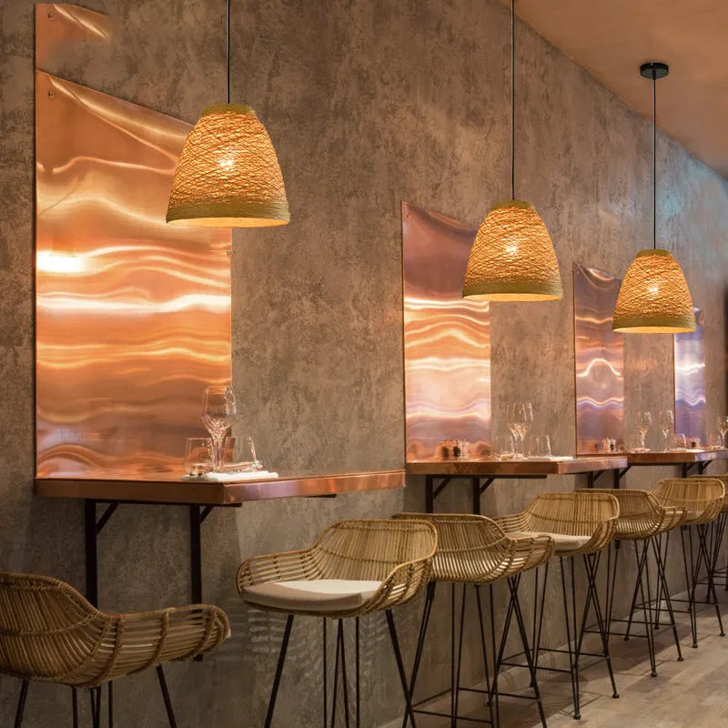Natural woven rattan hanging lamp with adjustable cord in a light coffee colour, suspended from a ceiling.