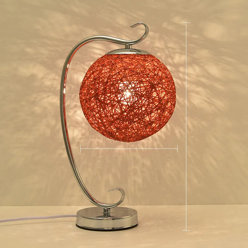 Dimmable LED table lamp with cloth shade and iron base, showing remote control and colour options.