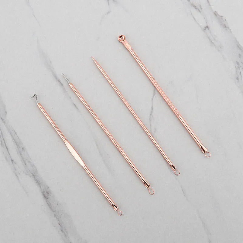 Rose gold acne needle set with four stainless steel tools on a white background