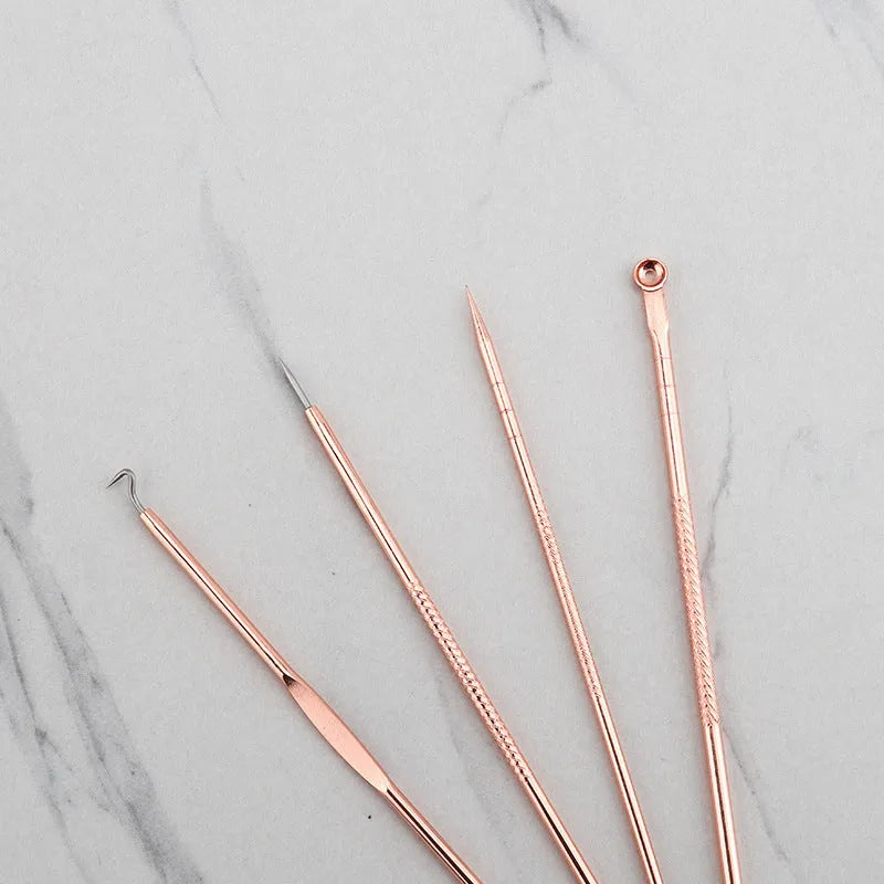 Rose gold acne needle set with four stainless steel tools on a white background