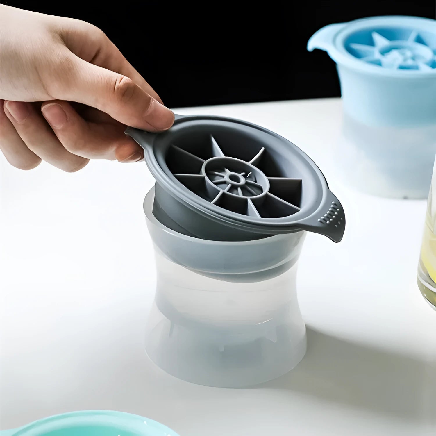 Silicone ice tray showing hockey puck, round, and pentagon shaped moulds in various colour options