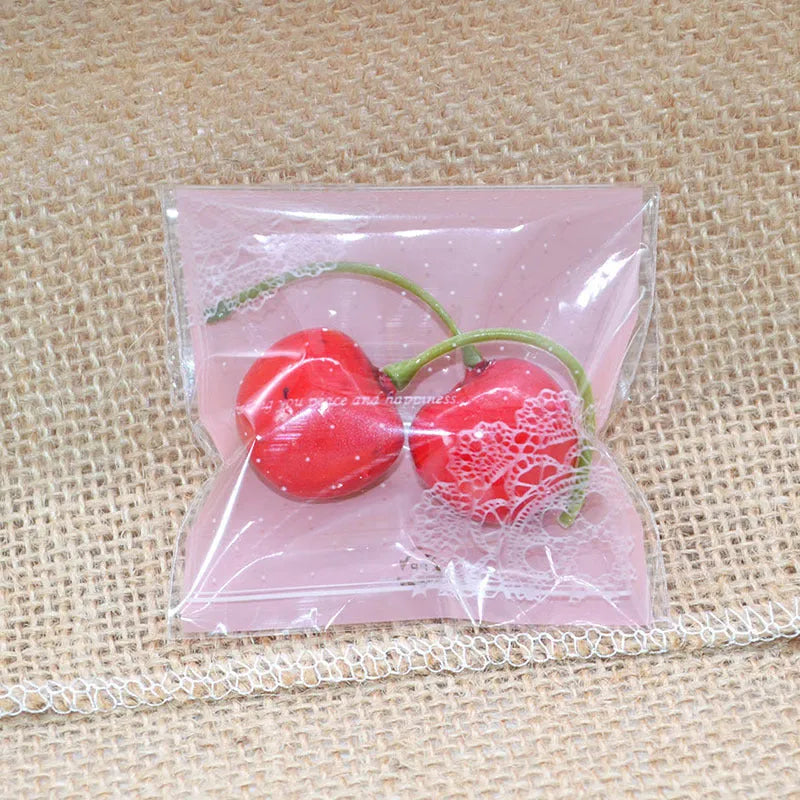 Pink self-adhesive plastic packaging bag showing adhesive strip and 7x7cm dimensions.