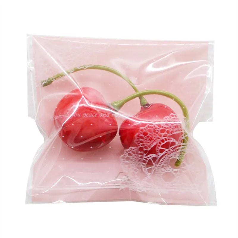 Pink self-adhesive plastic packaging bag showing adhesive strip and 7x7cm dimensions.