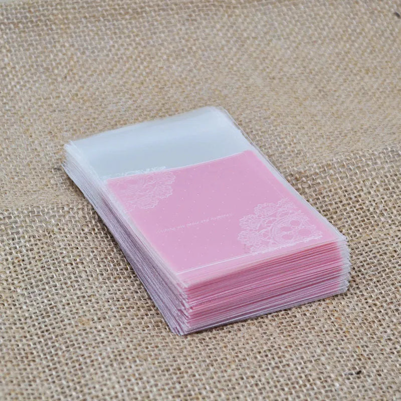 Pink self-adhesive plastic packaging bag showing adhesive strip and 7x7cm dimensions.
