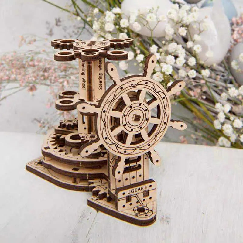 Wooden model of a rotating steering wheel that functions as a pen holder on a desk.