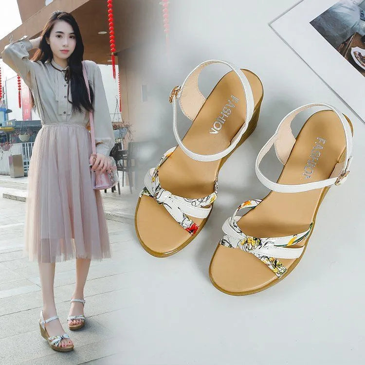 Pink women's wedge sandals with a thick heel, fish mouth opening, and a buckle strap.