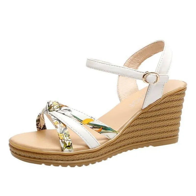 Pink women's wedge sandals with a thick heel, fish mouth opening, and a buckle strap.
