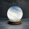 Nordic style bedside table lamp with glass lampshade on wooden table