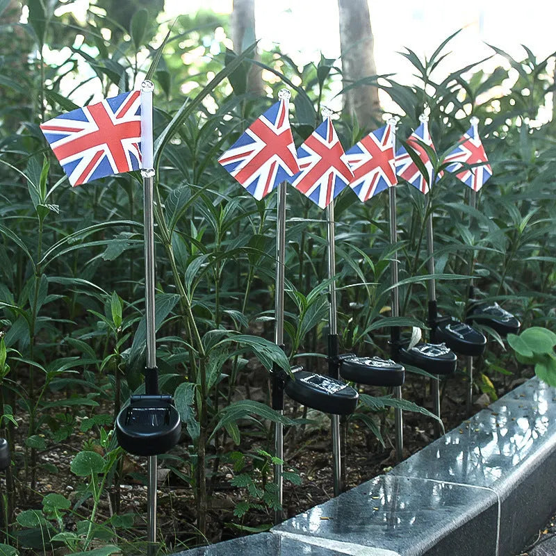 Solar garden flag light with stainless steel stake showing American flag design illuminated by white LEDs