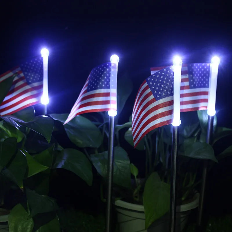 Solar garden flag light with stainless steel stake showing American flag design illuminated by white LEDs