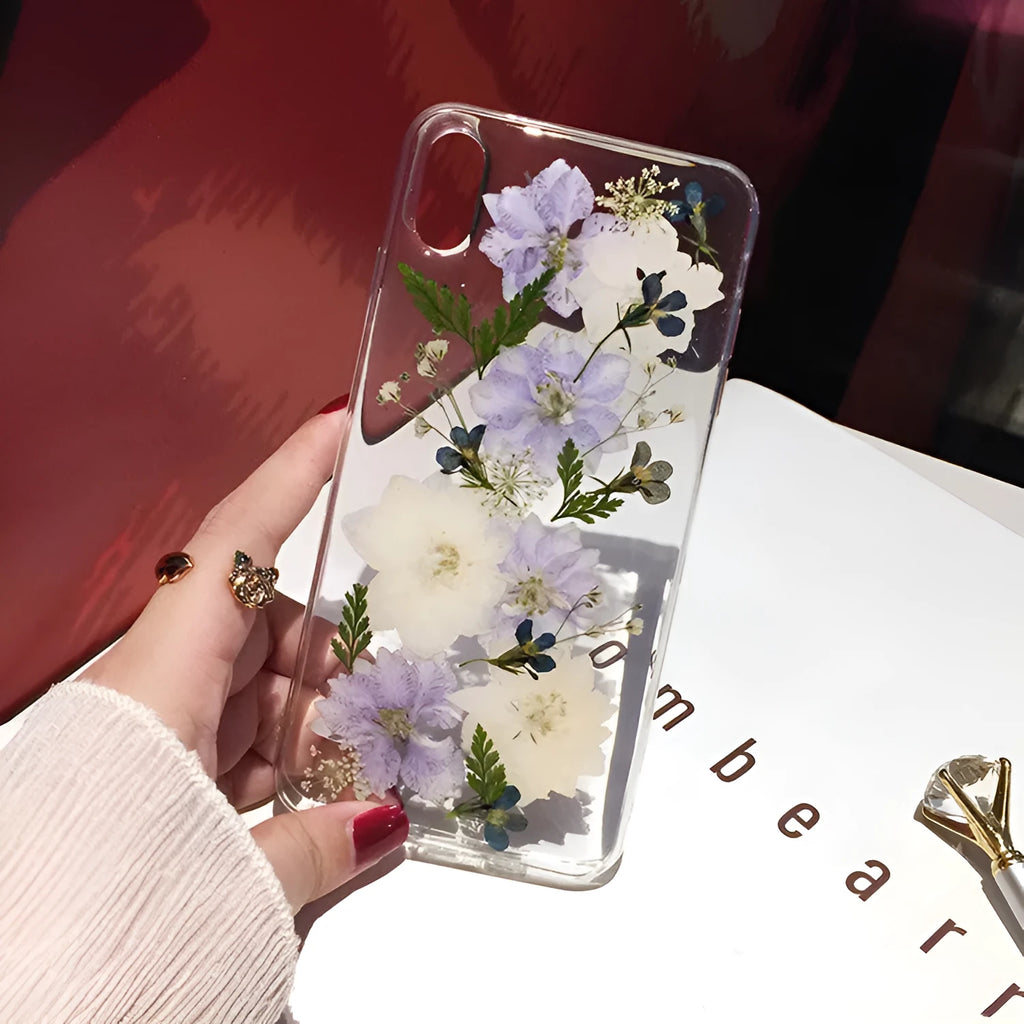 Soft blue and purple dried floral bouquet design on a transparent TPU case for an iPhone.