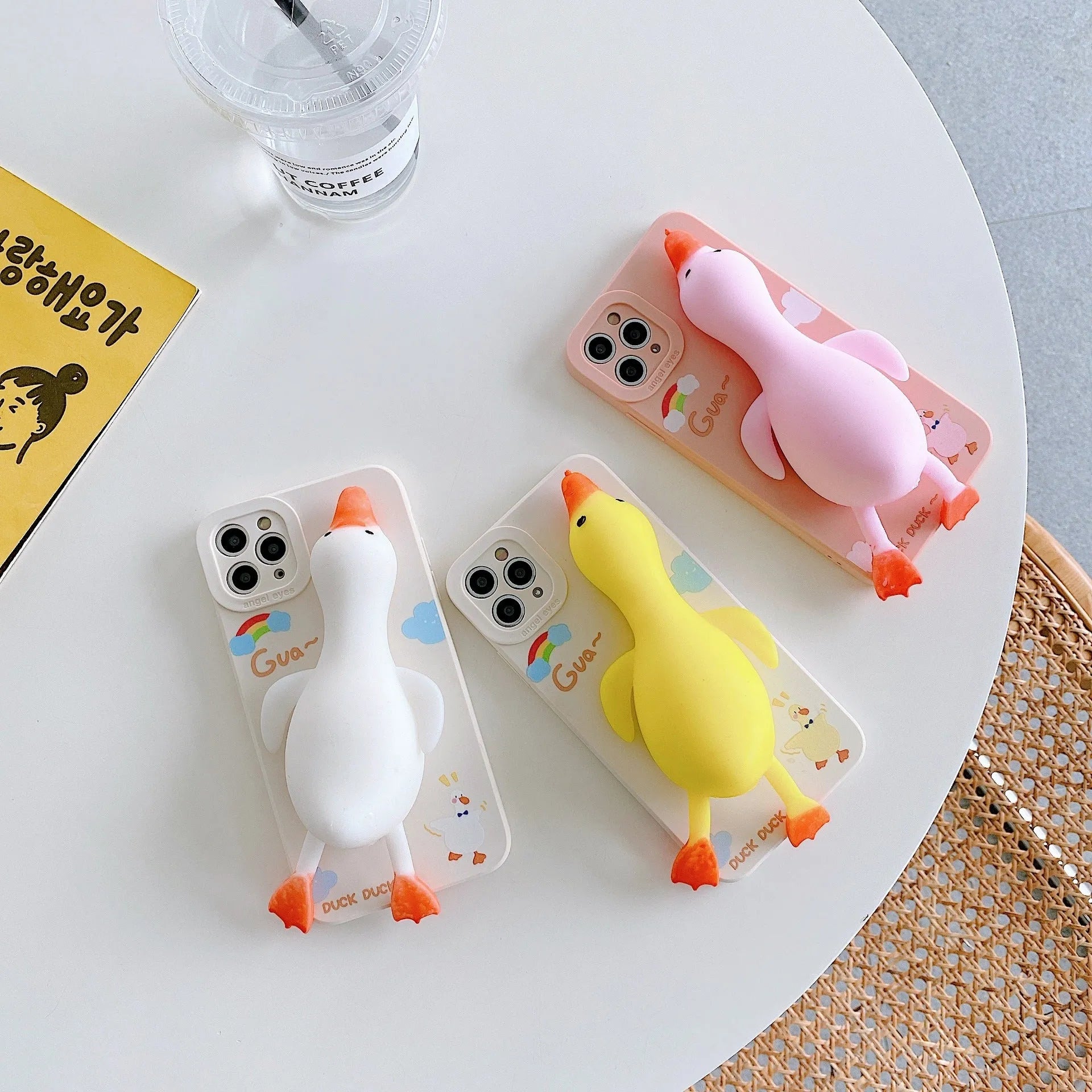 Cartoon printed silicone back cover case for iPhone on a yellow background.