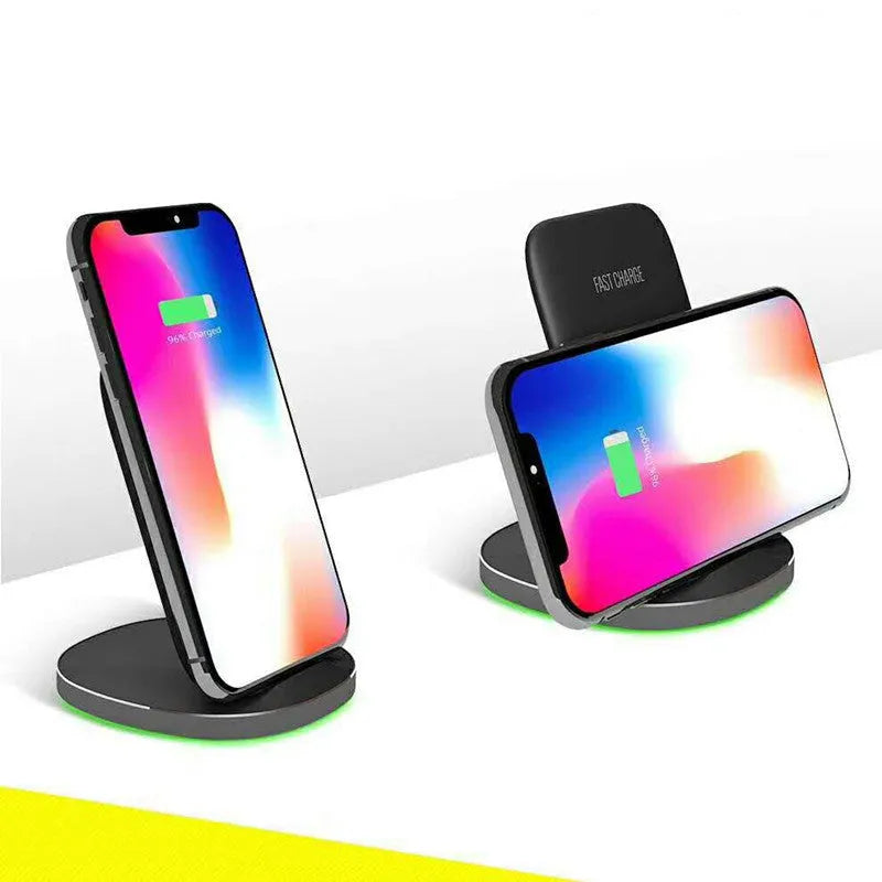 A white minimalist vertical wireless charging stand holding a smartphone upright on a desk.