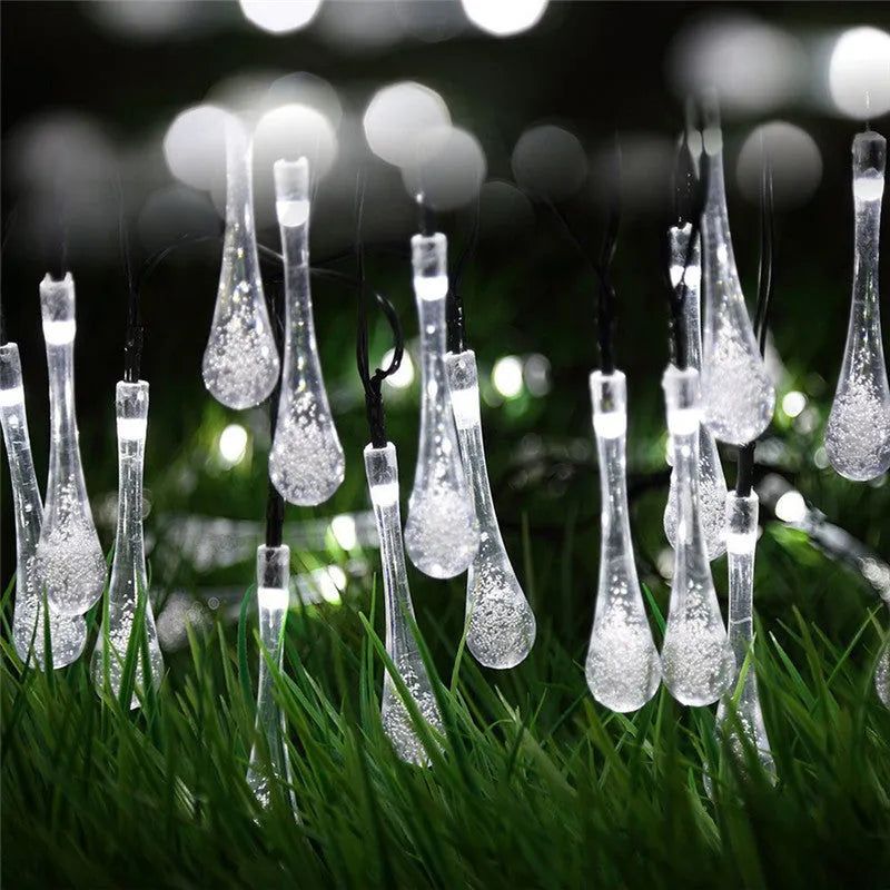 6.5 metre solar LED outdoor string lights with water drop bubble pendants in garden setting