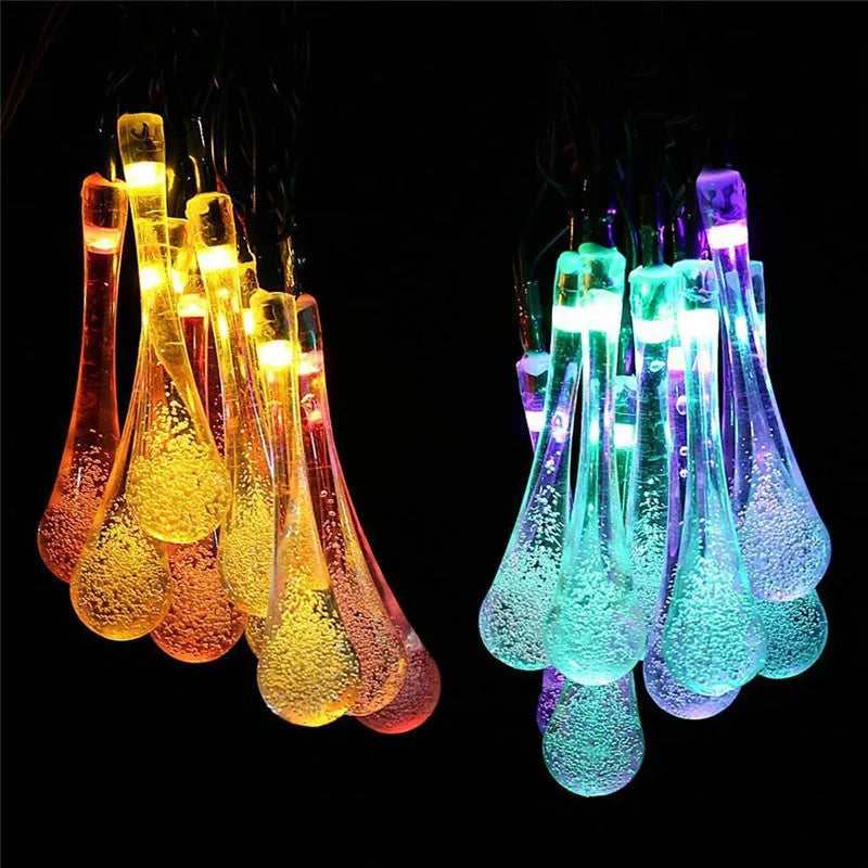 6.5 metre solar LED outdoor string lights with water drop bubble pendants in garden setting