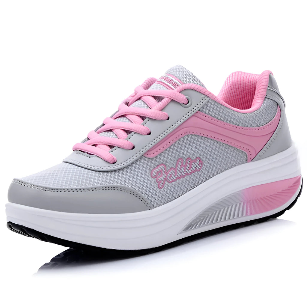 Women's grey and pink sports shoes with a middle heel on a plain background