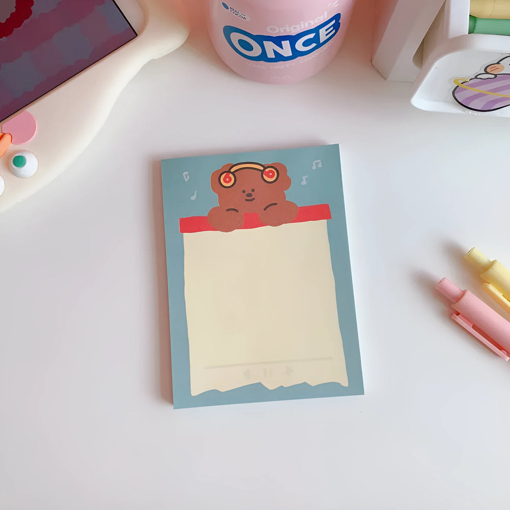 Kawaii cartoon bear design memo pad notepad with colourful cover, open to show paper pages.