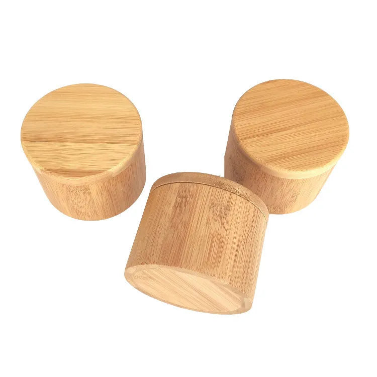Bamboo seasoning storage box with a matching bamboo spoon on a kitchen counter.