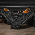Men's black microfiber casual leather shoes with round toe on a plain background