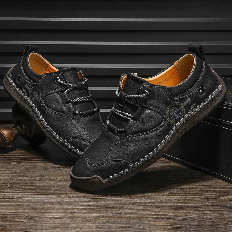 Men's black microfiber casual leather shoes with round toe on a plain background