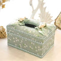 Bright apricot ceramic jewellery box with integrated tissue box holder on a dressing table.