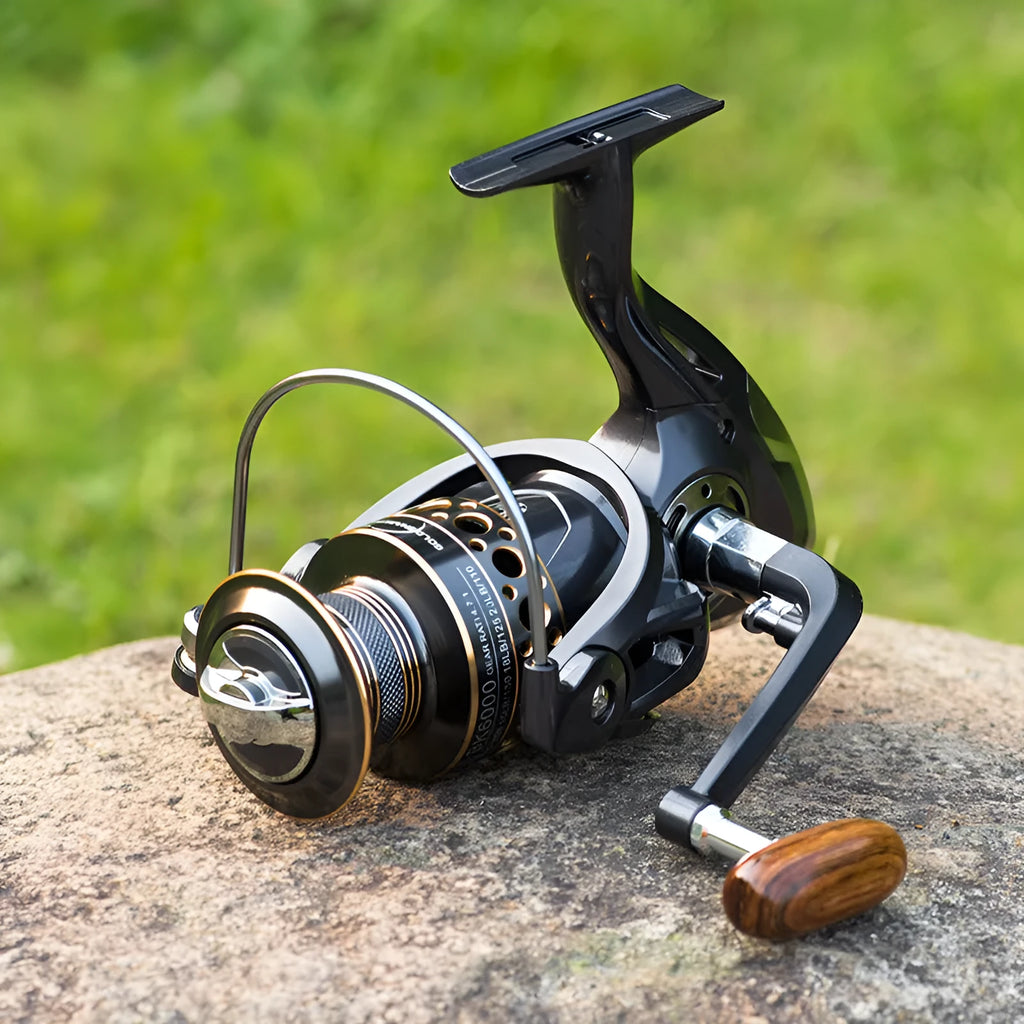 Telescopic fishing rod combo with carbon fibre rod and spinning reel with solid wood handle on a beach