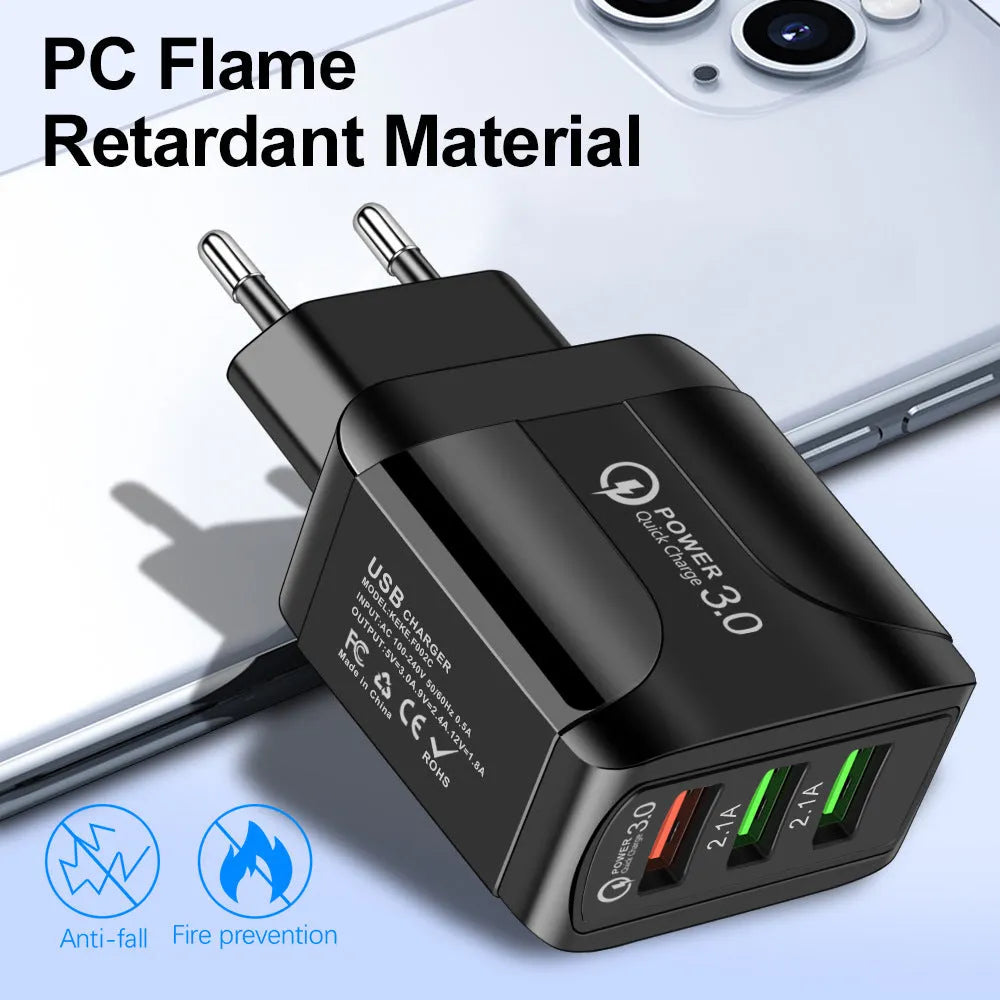 Black QC3.0 fast travel charger with three USB ports and a UK triangular plug attached.