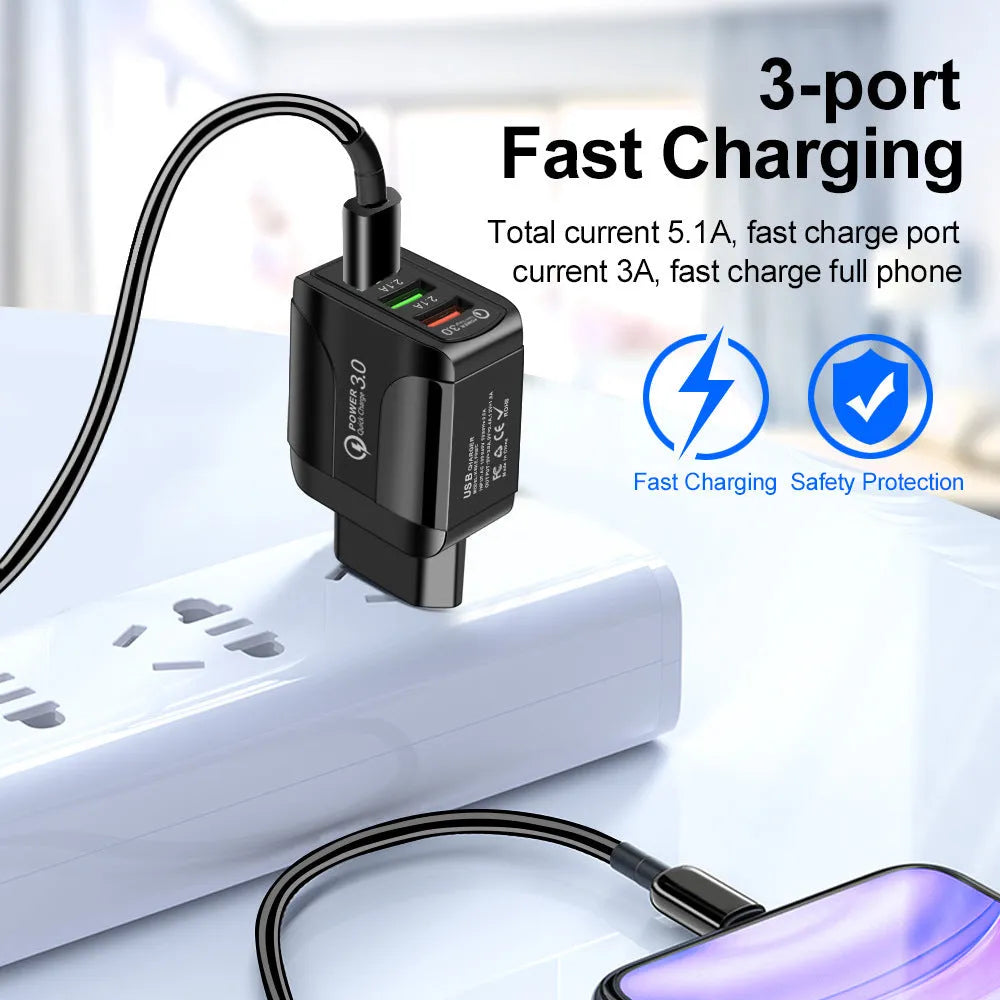 Black QC3.0 fast travel charger with three USB ports and a UK triangular plug attached.