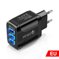 Black QC3.0 fast travel charger with three USB ports and a UK triangular plug attached.