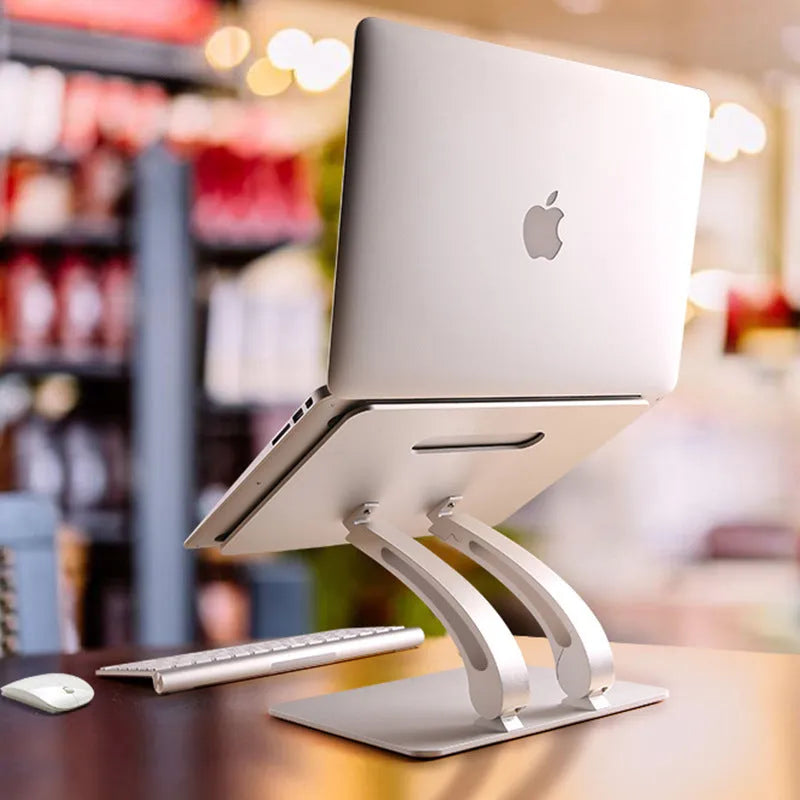 Aluminium alloy folding laptop stand in gray with open-frame cooling base, angled for use