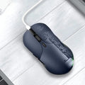 Blue wireless computer mouse with voice translation feature on a desk.