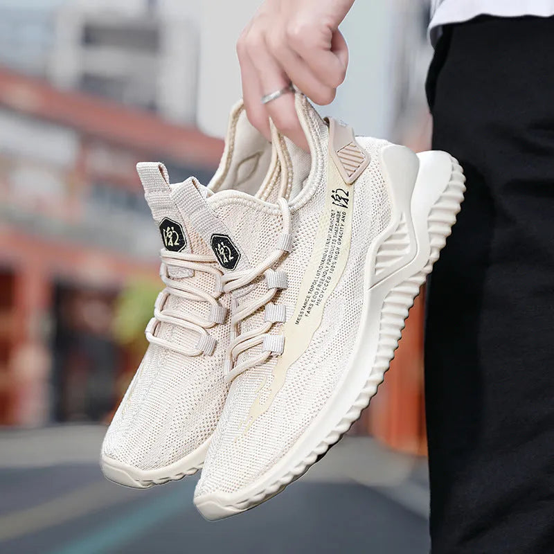 Men's white low-top sports shoes with mesh upper and rubber sole, laces tied.
