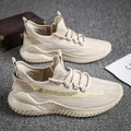 Men's white low-top sports shoes with mesh upper and rubber sole, laces tied.