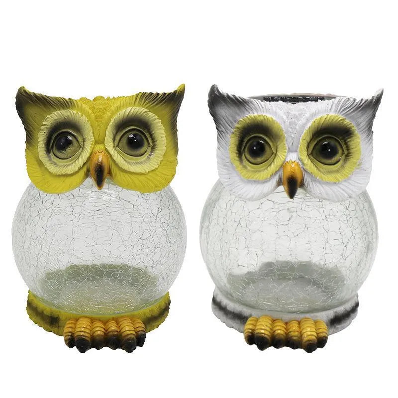 White solar powered LED owl shaped outdoor light on a garden patio.