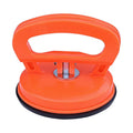 PDR car dent repair tool with large orange suction cup and plastic handle