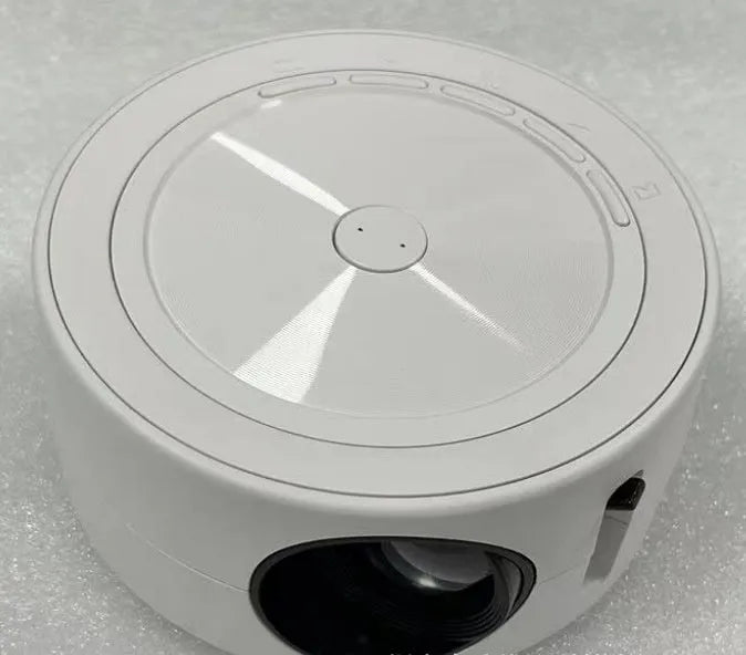 YT200 portable wired LED projector in black showing compact 110mm design with remote control