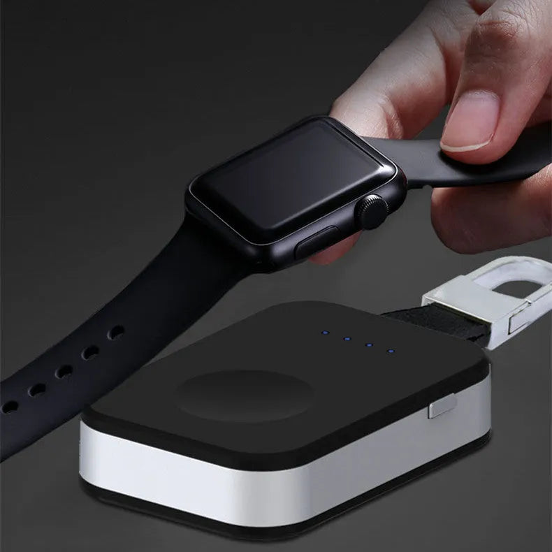 Black Apple Watch portable power bank keychain charger on a keyring.