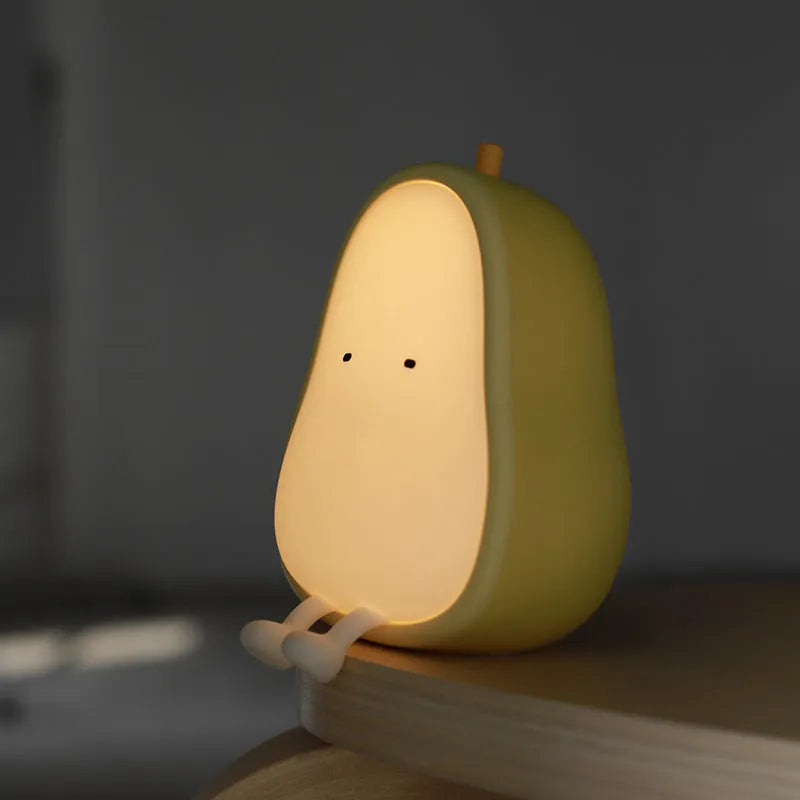 Pear-shaped silicone bedside night lamp with warm yellow glow and compact design