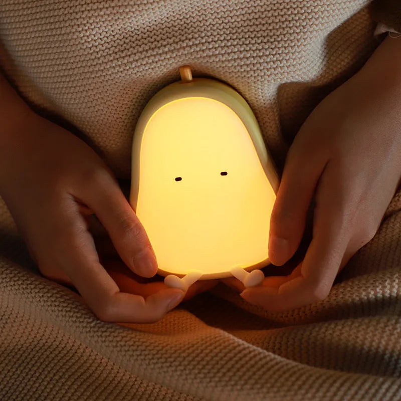 Pear-shaped silicone bedside night lamp with warm yellow glow and compact design