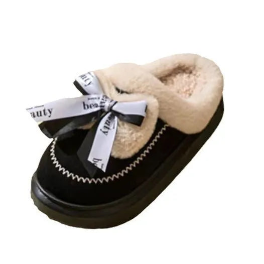 Women's beige suede half slippers with a thick sole and wool lining on a wooden floor.