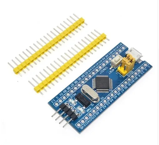 STM32F103C8T6 ARM STM32 minimum system development board module showing microcontroller chip, USB port, and pin headers.