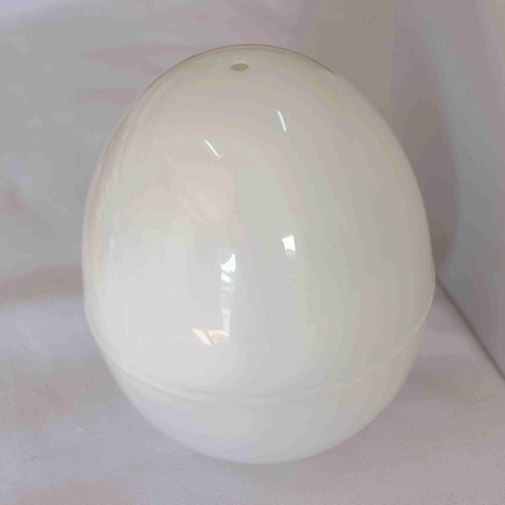 White microwave egg cooker steamer with capacity for four eggs, made from food grade plastic and aluminium.