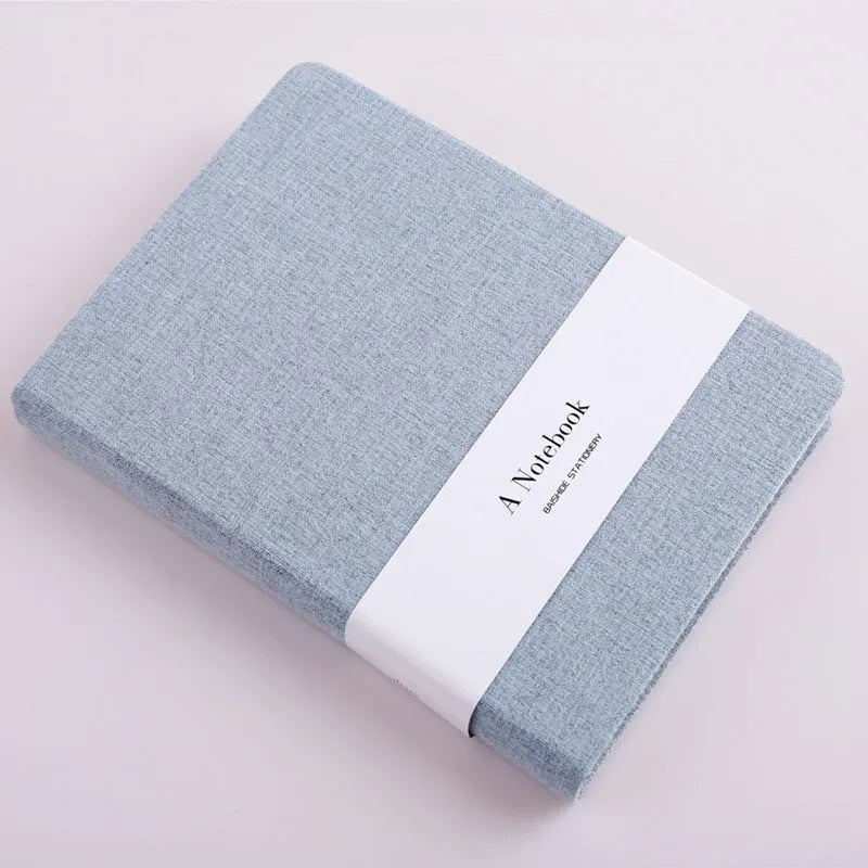 Cloth-covered wire-bound notebook with 132 pages, small size 10.5x14.5cm, showing blank and ruled pages in blue