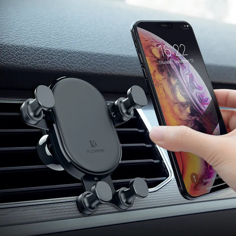Black gravity car phone holder mounted on car vent with smartphone secured in 360-degree rotating cradle