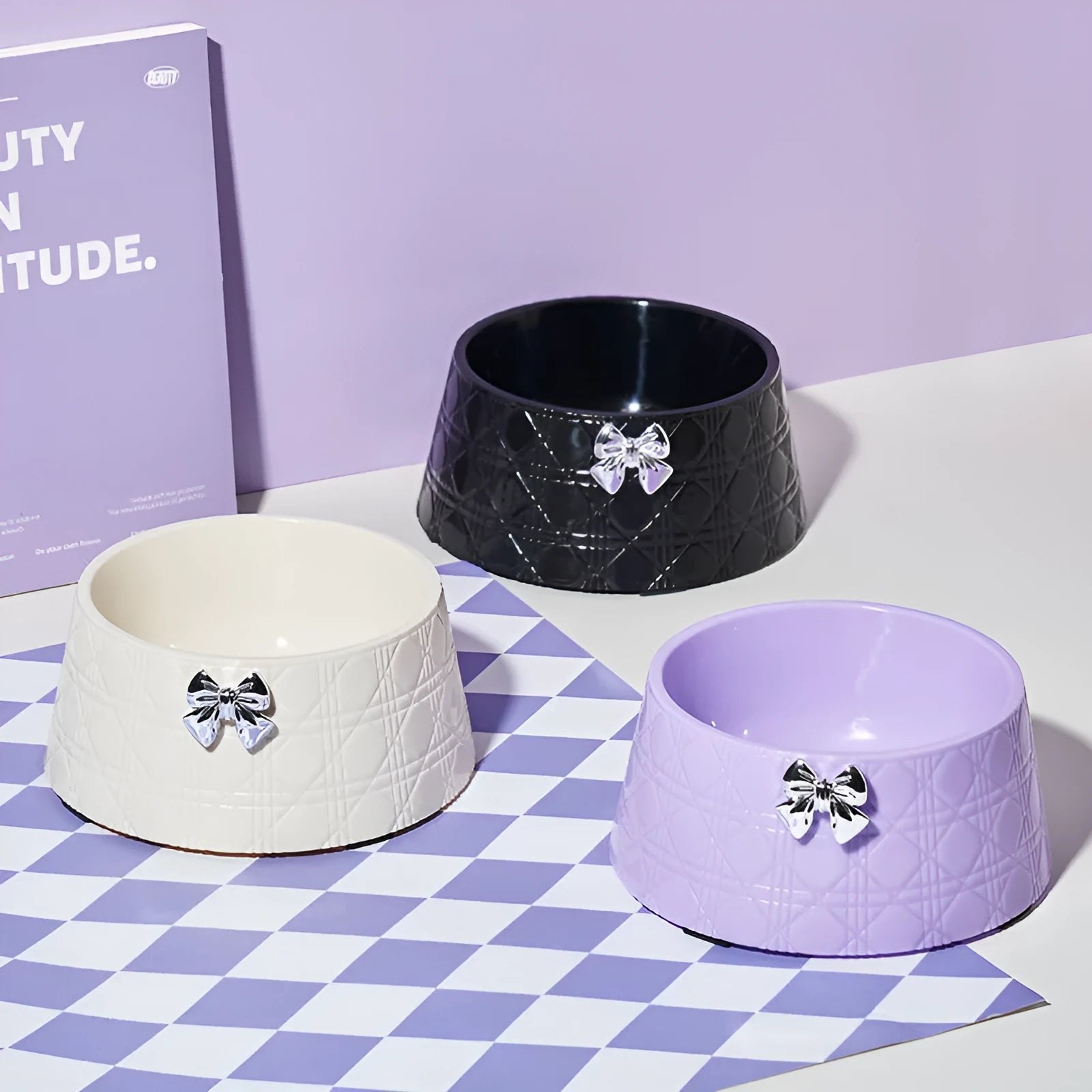 Pet food bowl with diamond pattern and a decorative bow design in a choice of colours.
