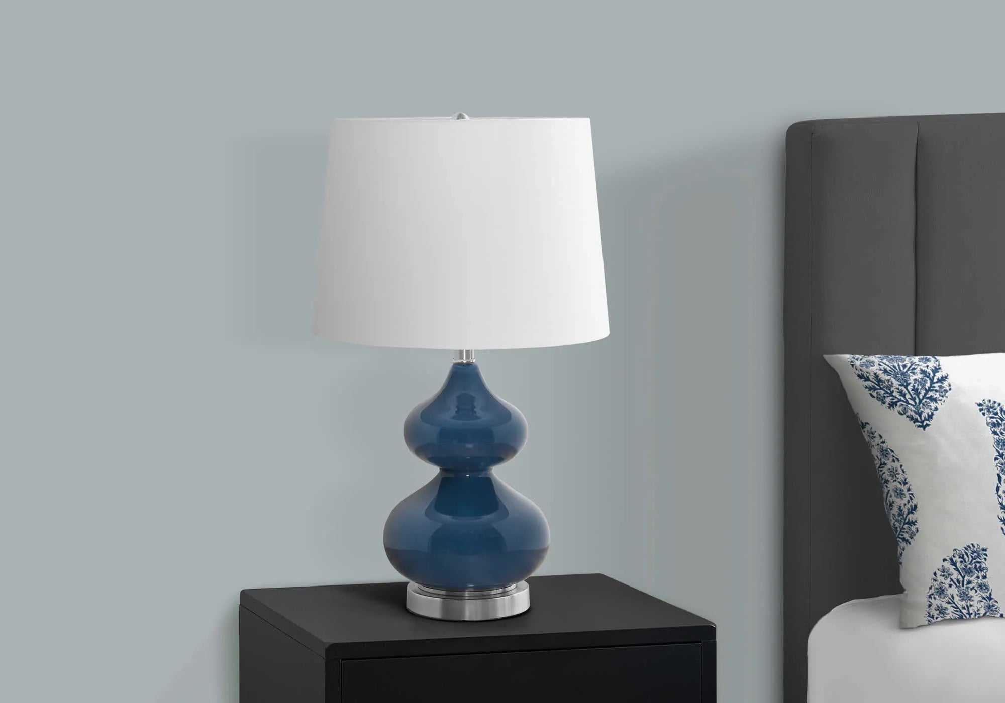 Blue crystal glass desk lamp with a cloth shade for a child's bedroom, shown on a desk.