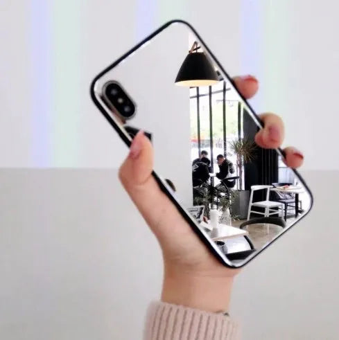 Black iPhone mirror phone case showing reflective surface on back, compatible with iPhone X and Plus models.