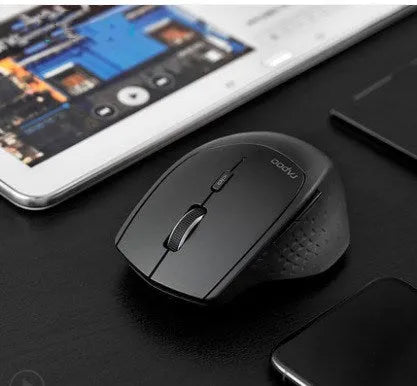 Rapoo MT500 wireless Bluetooth mouse in black with six buttons on a desk surface