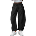 Women's loose cropped sweatpants in apricot colour with drawstring waist and side pockets on a neutral background.