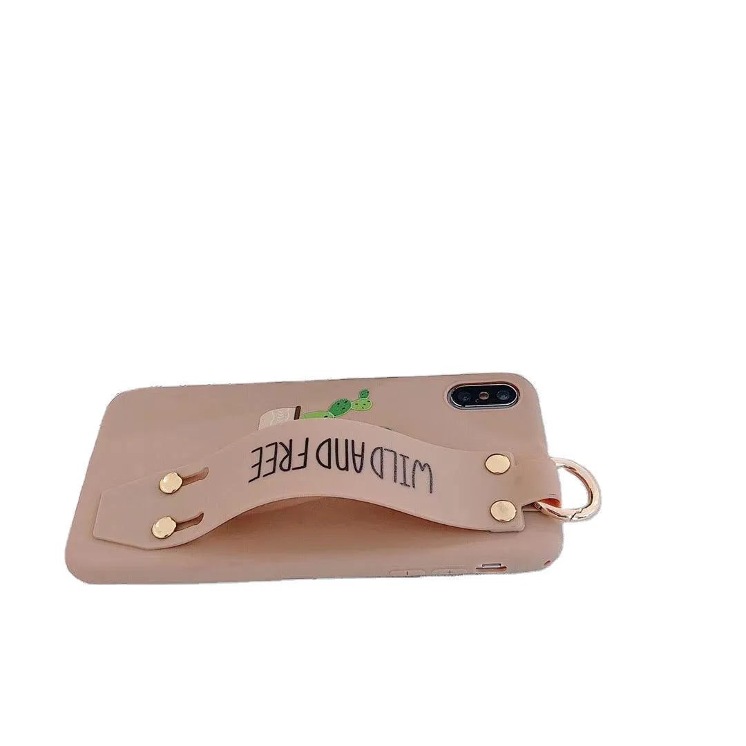 Green graffiti design wristband holder phone case for iPhone on a table.